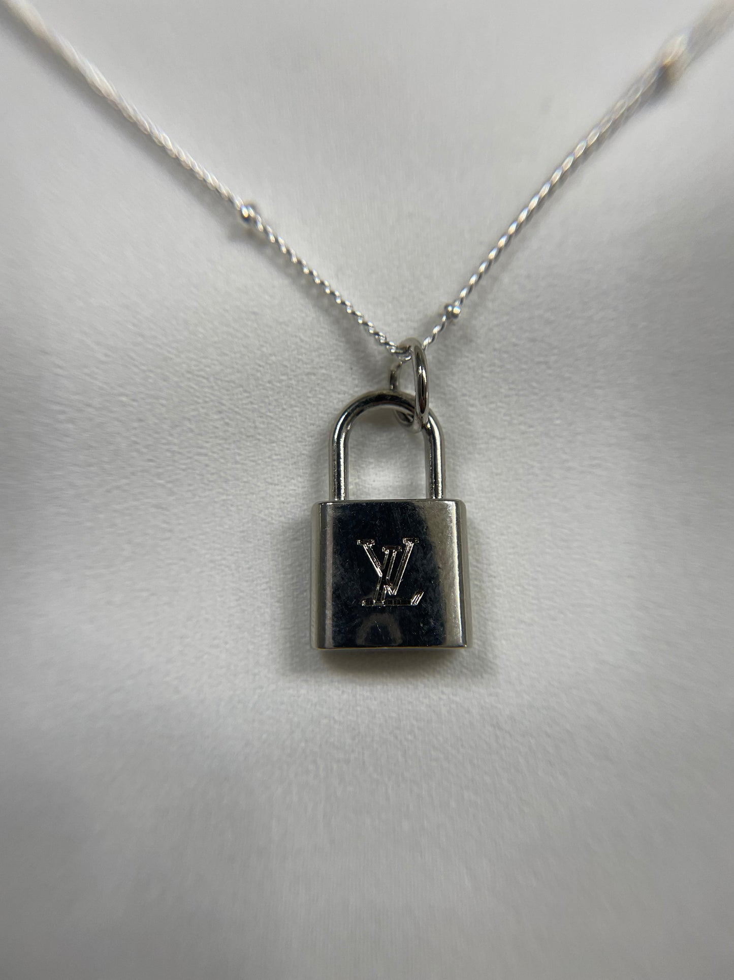 AUTHENTIC LOUIS VUITTON SILVERTONE ZIPPER PULL PADLOCK PENDANT NECKLACE.